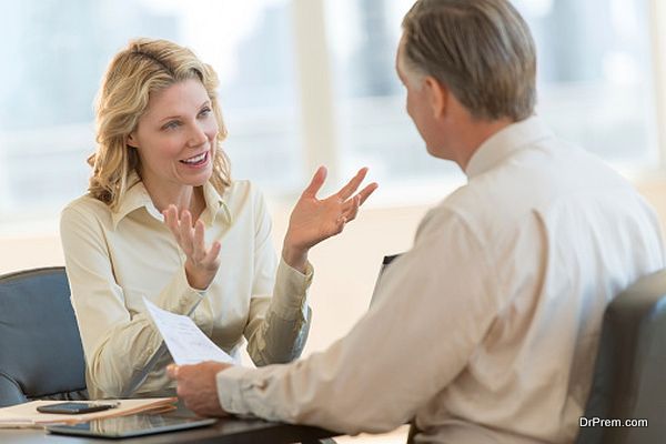 Businesswoman Discussing With Colleague In Office