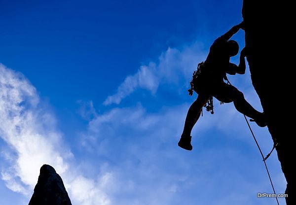 Silhouetted climber and rock spires