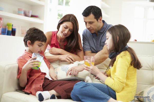 Family Playing With Digital Tablet And MP3 Player