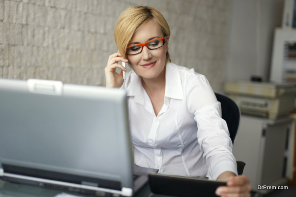 Young blonde businesswoman call in office