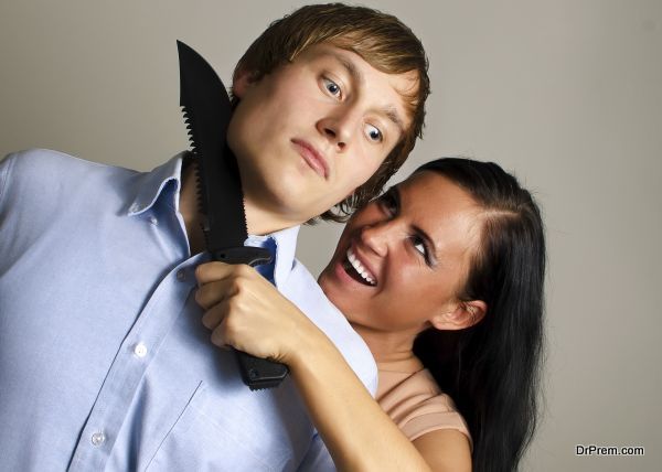 Woman is trying to kill man by knife.