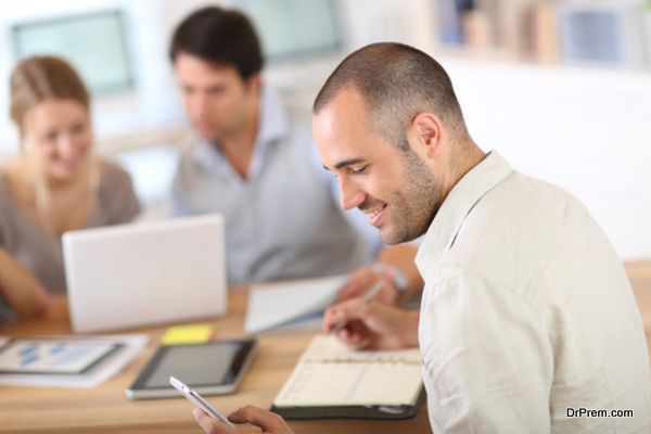 Man in office writing on agenda