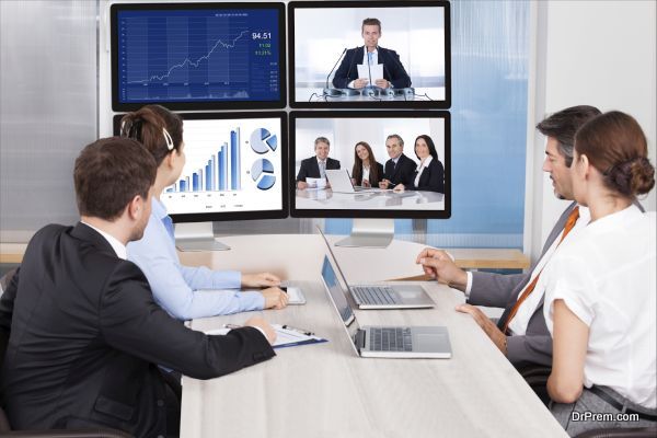 Businesspeople Sitting In A Conference Room Looking At Computer Screen