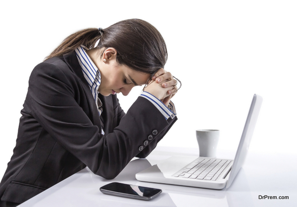 Portrait of stressed and tired young business woman with a laptop computer on white background