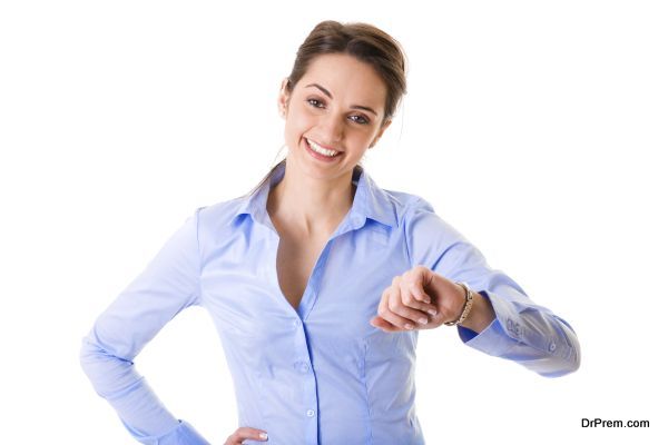 young businesswoman checks time on her wrist watch, time, late concept, studio shoot isolated on white