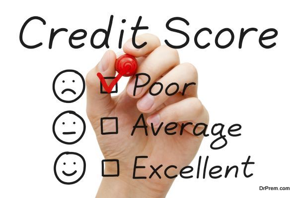 Hand putting check mark with red marker on poor credit score evaluation form.