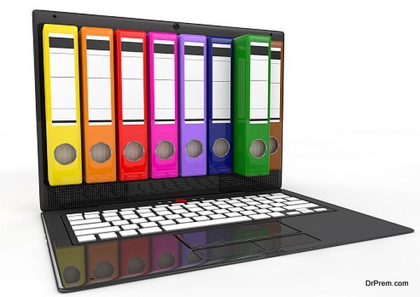 file in database. laptop with colored ring binders