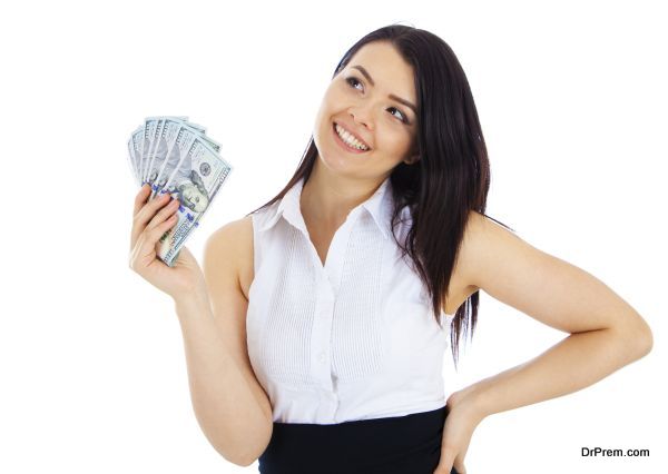 Dreaming business woman with cash in hand