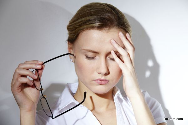 Portrait of young businesswoman having headache pains