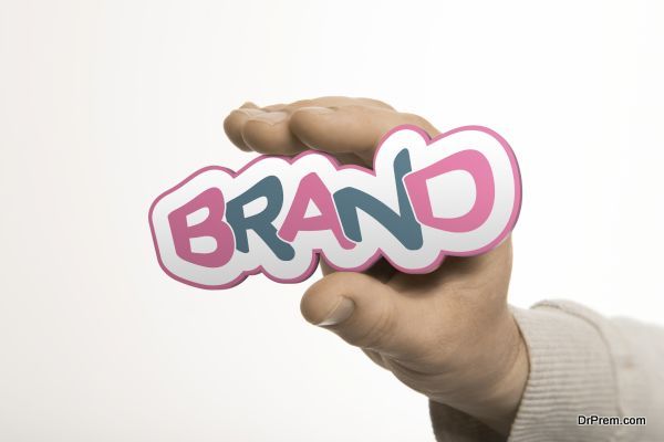 One hand holding the word brand over a white background. Company identity concept. The image is a composition between 3D rendering and photography