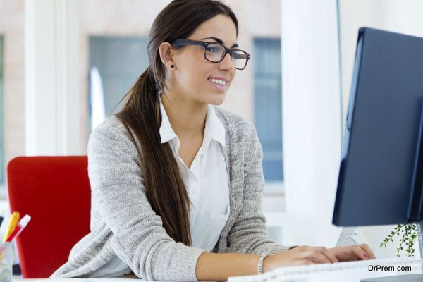 Young businesswoman working in her office with laptop.