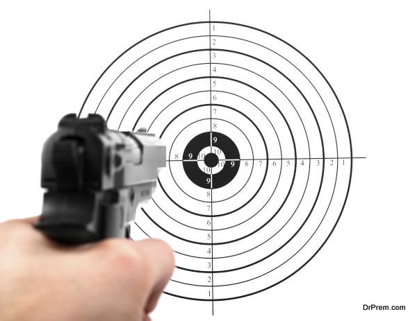 hand with gun shooting target