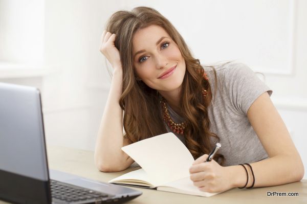 Student. Attractive girl by the table