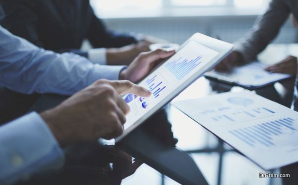 Image of businessperson pointing at document in touchpad at meeting