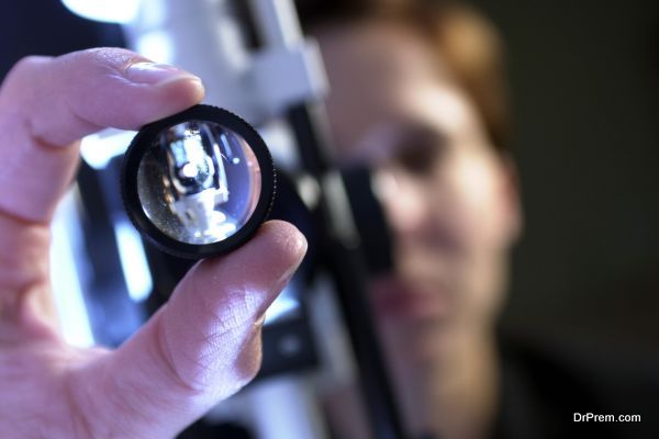 Ophthalmologist adjusting slit lamp