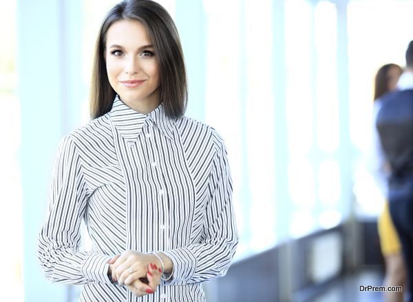 Beautiful business woman smiling and looking at camera in a modern office