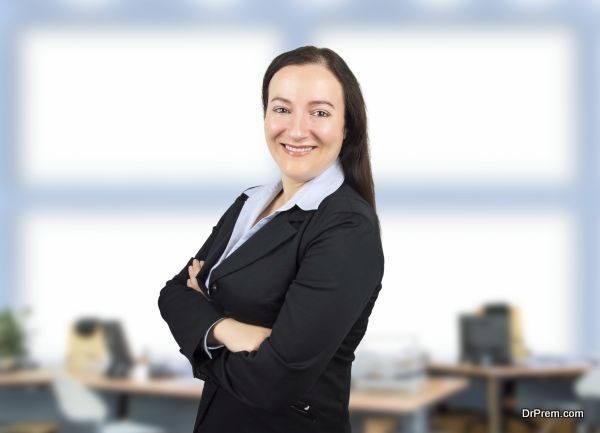 Portrait of a businesswoman standing at the office with arms crossed and smiling