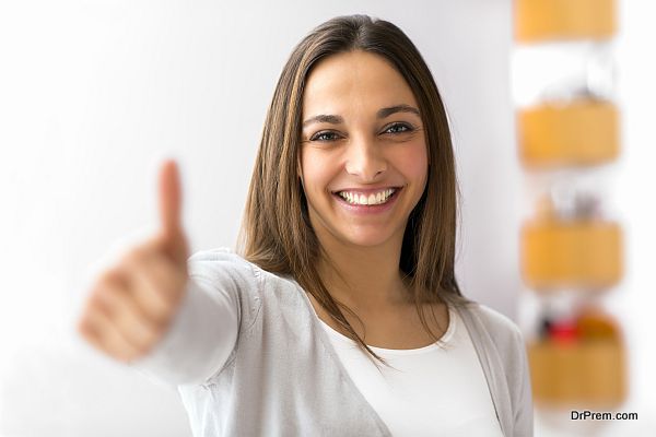 Happy female smiling with her thumbs up