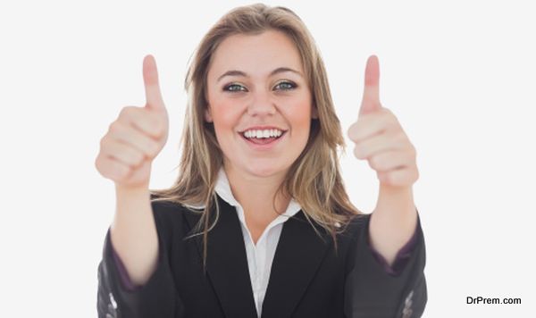 Happy business woman gesturing thumbs up