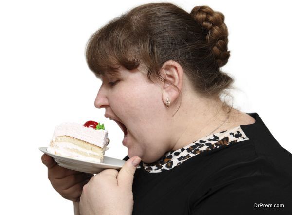 overweight woman biting cake