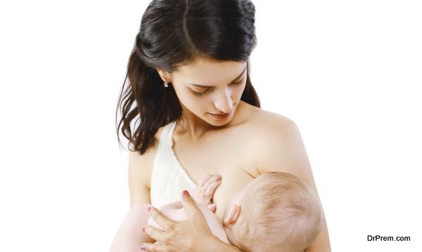 Mother feeding breast her baby on a white background