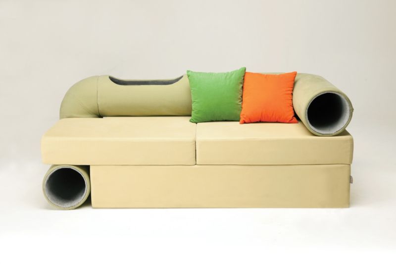 The Cat Tunnel Sofa True to its name, the Cat Tunnel Sofa consists of a comfortable sofa with a tunnel that runs along the arm, side and back of the sofa. Looking sleek and elegant, the sofa is the perfect place for you to relax and watch TV while you cat runs through the tubes, jumps out of any one of the three openings in it, plays with you, or cuddles up in a warm, protective corner inside the tunnel.