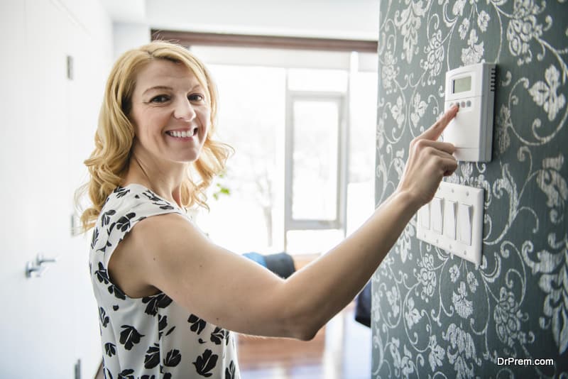 woman using Programmable Thermostat