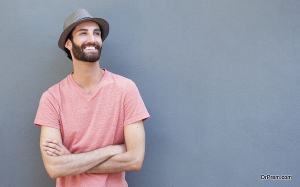 Attractive young man smiling with arms crossed