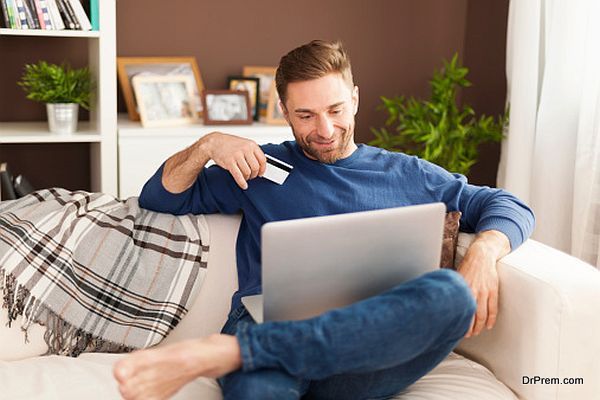 Smiling man during online shopping at home