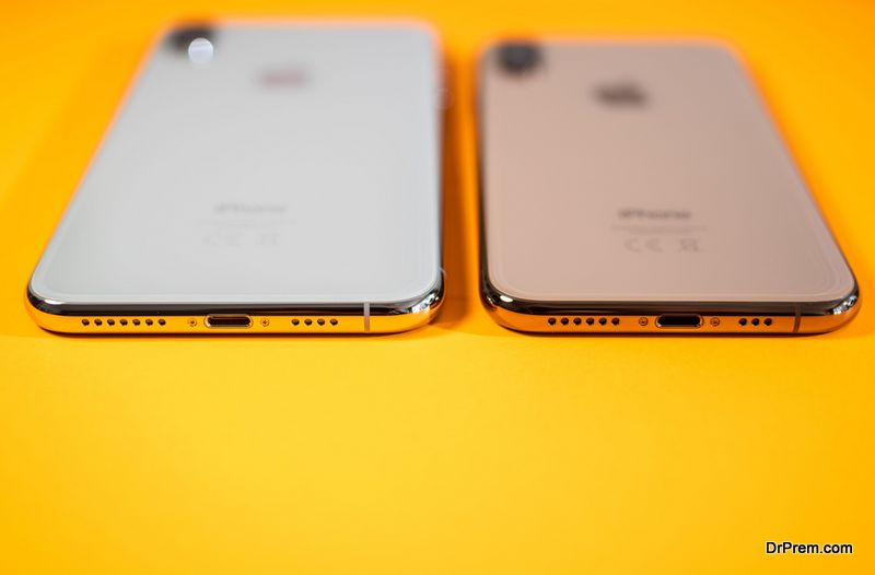 rear view of Apple iPhone Xs Max orange background