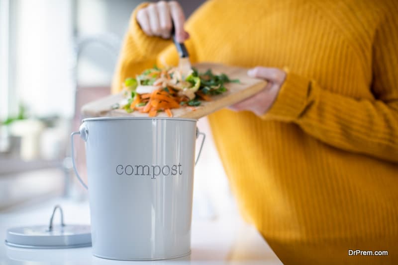 Close Up Of Woman Making Compost From Vegetable Leftovers In 