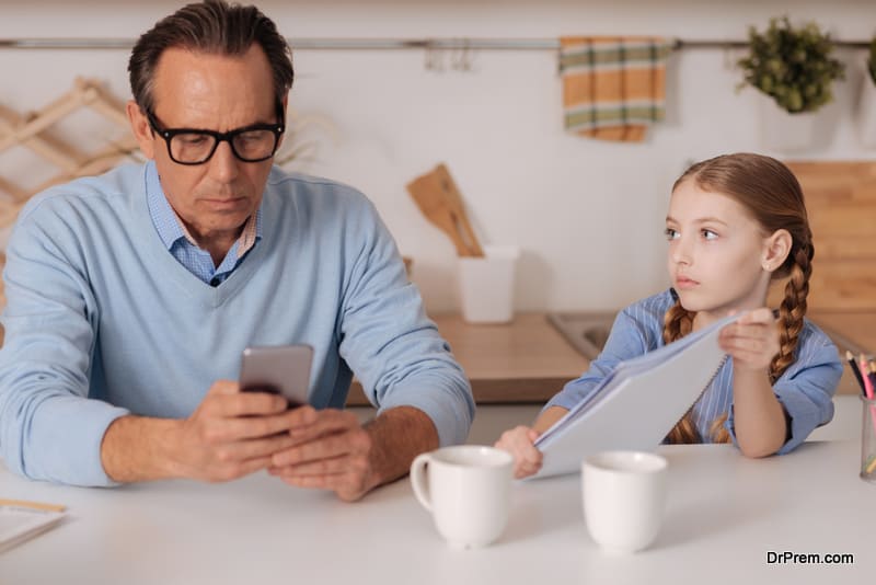 father busy on smartphone