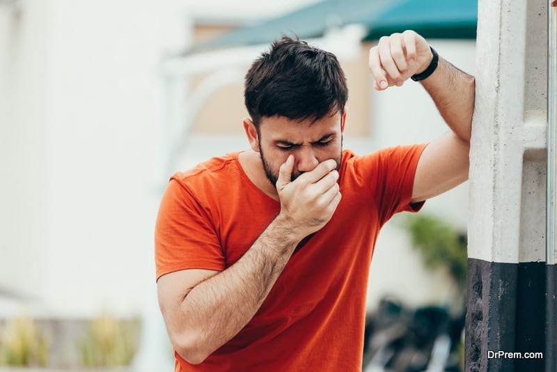 young man drunk or sick vomiting outdoors