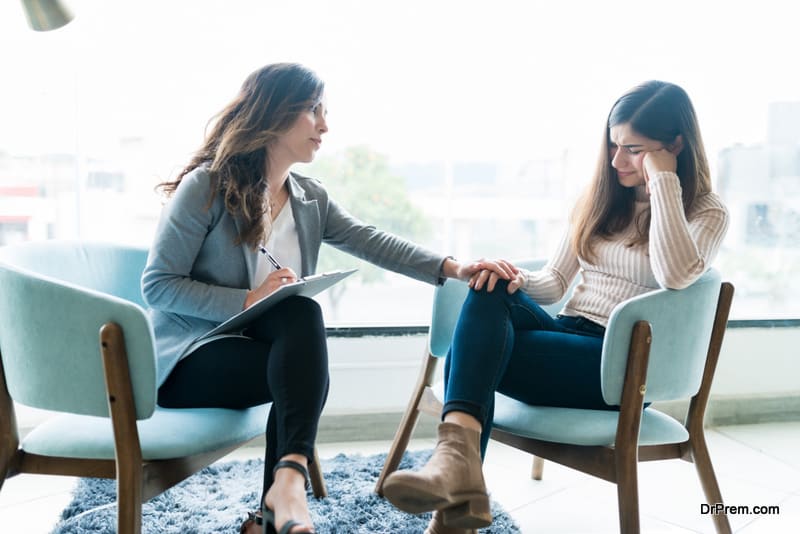 Therapist Giving Support To Crying Female Patient