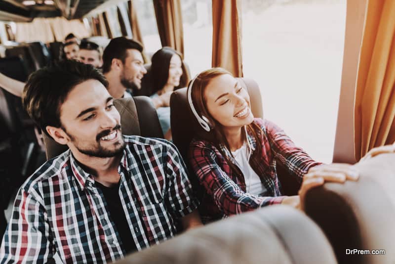 Young Smiling Couple Traveling on Tourist Bus