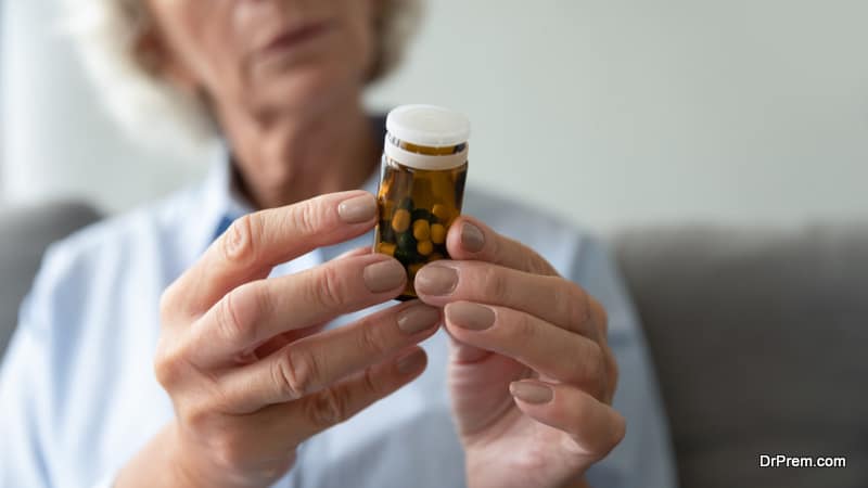 senior woman reading label of medicine