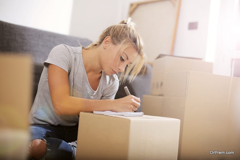 woman-working-on-Moving-Out-Checklist