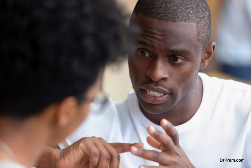 Focused african man having serious talk with woman at meeting 