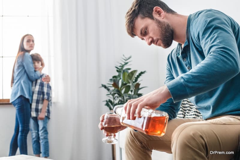 alcoholism-man-pouring-whiskey-into-glass