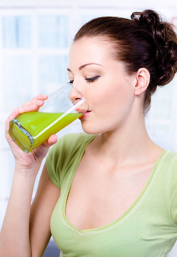 Beautiful young girl drinking fresh orange juice