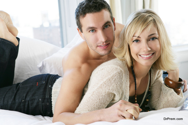 Young happy couple in bed