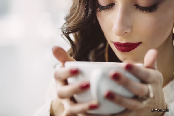 Young girl drinking coffee in a trendy cafe