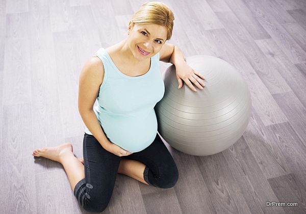 Pregnant woman resting on Fitness Ball.