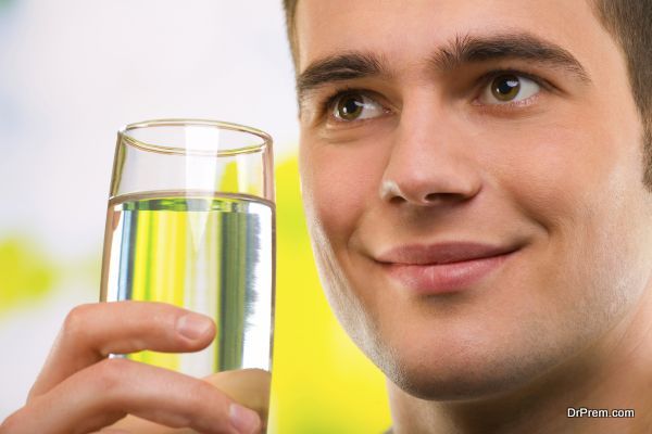 Portrait of young man with glass of water