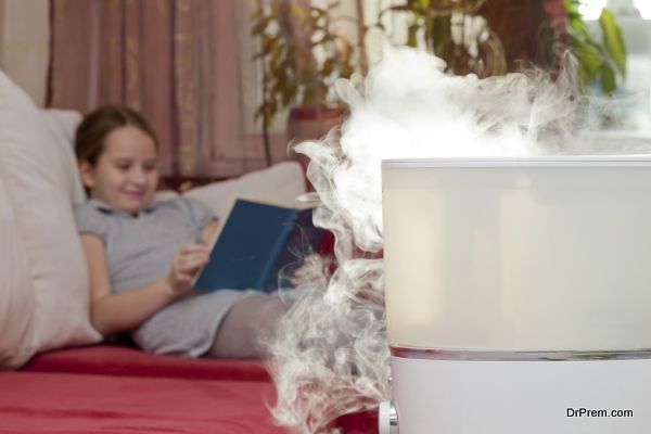 Girl reading book on the background of humidifier