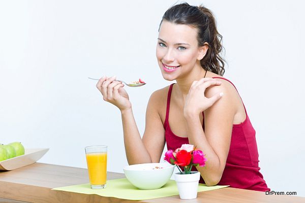 Young woman taking a breakfast cereal at home