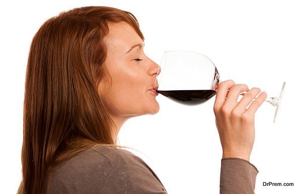 Attractive brunette with a glass of wine isolated