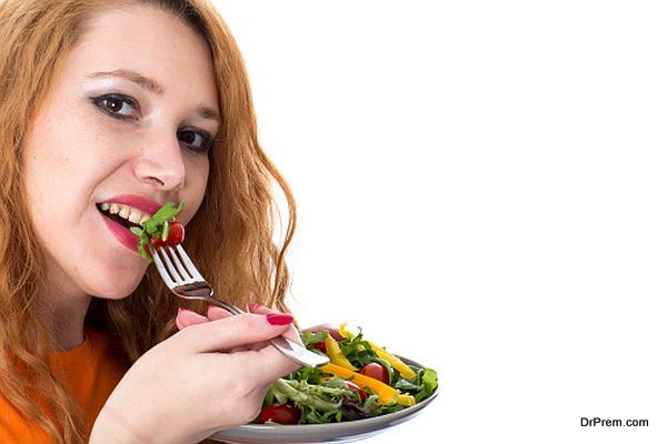 Happy Young Woman Eating Salad