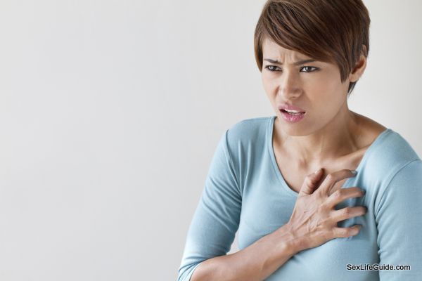 sick woman with sudden heart attack symptom