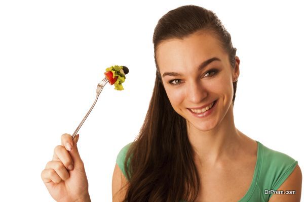 Beautiful asian caucasian woman with a white bowl of mixed salad isolated over white promoting healthy eating and lifestyle